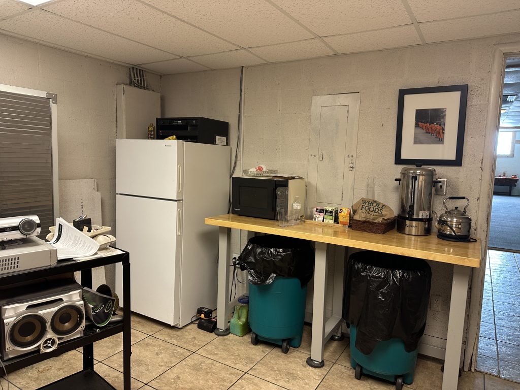 Kitchenette with refrigerator, microwave, and tea service at Windsong Innerspace